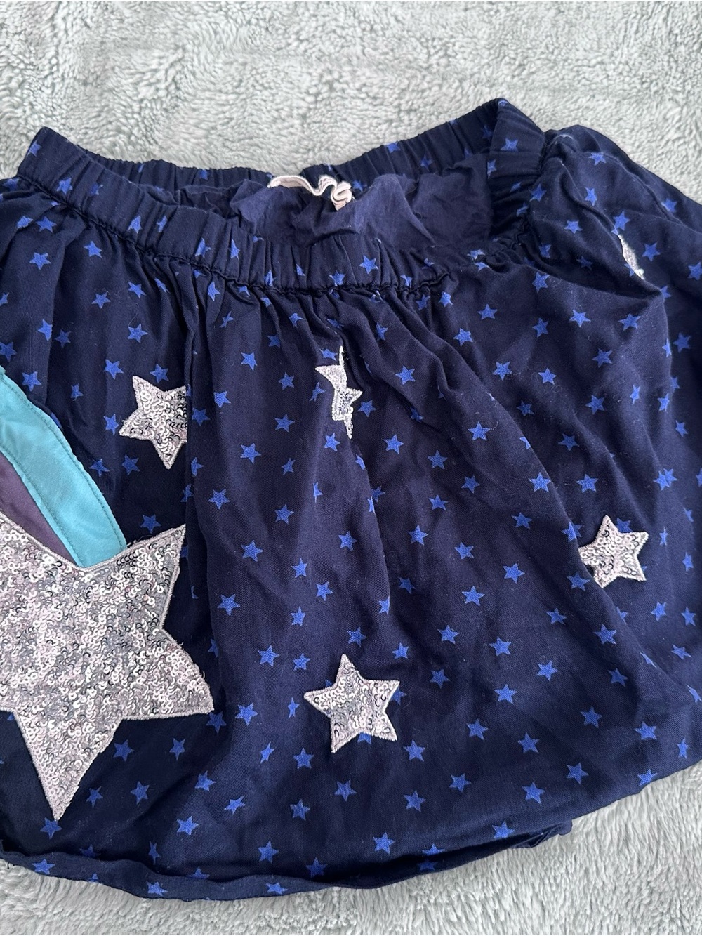 Mini Boden Navy and Blue Star Skirt with Sequin Accents and rainbow appliqué.